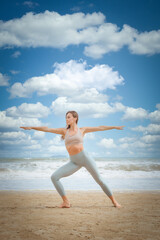 Fototapeta na wymiar Young healthy Yoga woman workout yoga pose on the beach at daytime