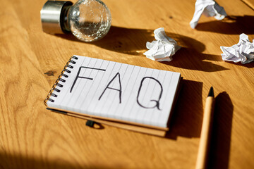 Faq, frequently asked questions text on notebook .on wooden  background, Social Online Business...