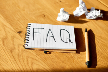 Faq, frequently asked questions text on notebook .on wooden  background, Social Online Business...