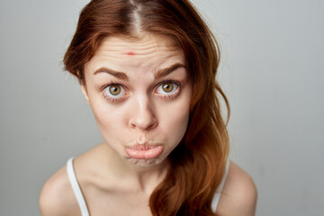 beautiful woman with a pimple on the face isolated background