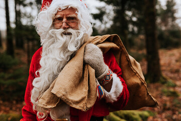 Man wearing Santa costume carrying sack