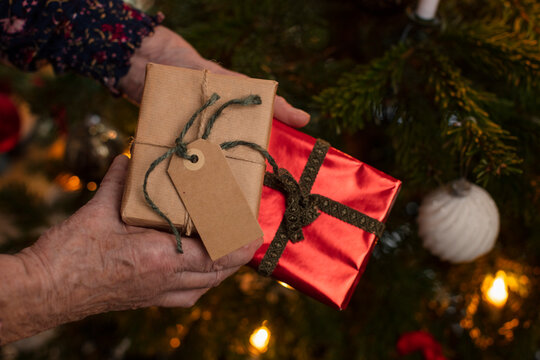 Woman's hands holding Christmas presents