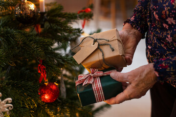Woman's hands holding Christmas presents