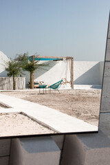 greek view near swimming pool with nobody in mirror reflection. white villa in greece. travel concept, free space