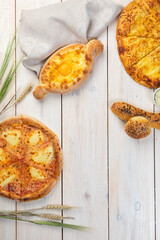Traditional Georgian bread - khachapuri on the table. Homemade baking.