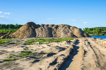 A pile of sand in a quarry to be transported by trucks for road construction or concrete production