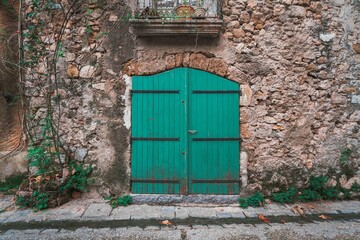 European retro green wooden door and stone wall background