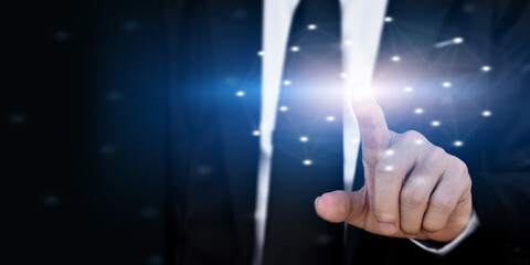 Businessman hand touching virtual screen on dark background with copy space