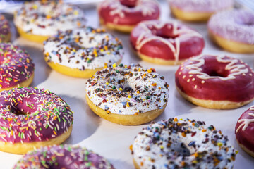 donuts with different flavors, fillings and different sprinkles