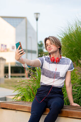 Young gay man taking selfie with mobile phone