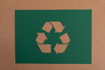 Green recycle sign, three arrows on paper cut