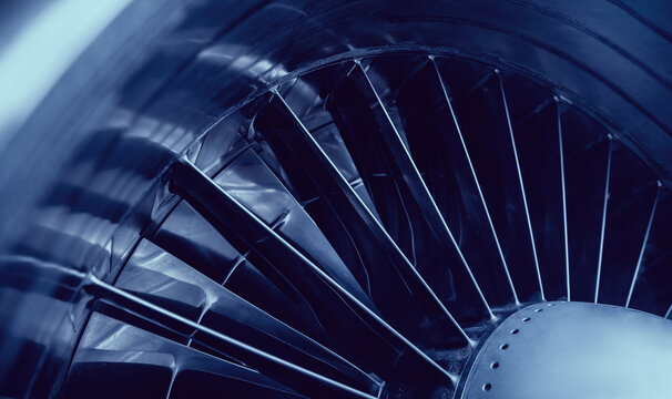 Closeup jet engine blades of airplane. Blue color tone