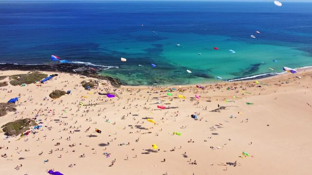 kite fest fuerteventura, Spain , festival de cometas , kite in turquoise water and white beach in canary island, drone 4K footage