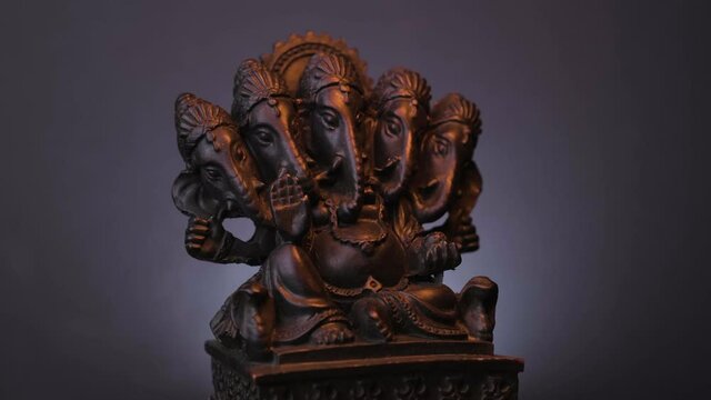 Brown Sculpture Five-Headed Ganasha Spinning With Shining Light. - Close up 