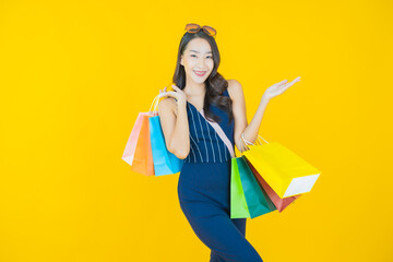 Portrait beautiful young asian woman smile with shopping bag