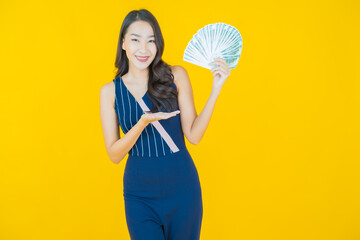 Portrait beautiful young asian woman smile with a lot of cash and money