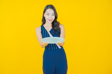 Portrait beautiful young asian woman smile with empty plate dish