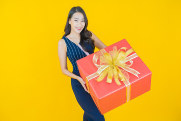 Portrait beautiful young asian woman smile with red gift box