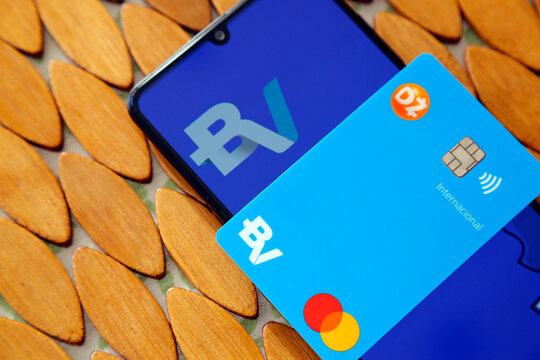 BV bank logo on mobile cell phone screen and credit card. Digital payment system.