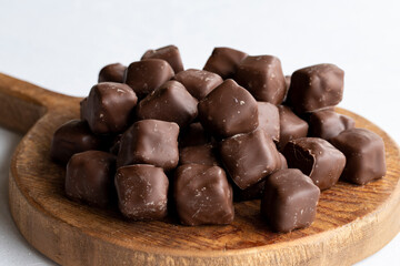 Chocolate covered Turkish delight on a white background. Traditional Turkish cuisine flavor. Close up
