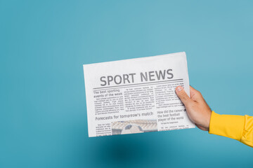 cropped view of man holding newspaper with sport news on blue - obrazy, fototapety, plakaty