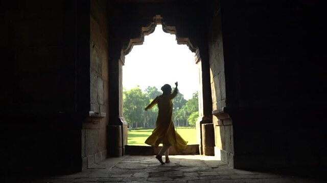 Silhouette of Indian girl performing classical dance, India