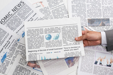 Obraz premium top view of businessman holding newspaper
