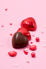 Beautiful Red Chocolate Hearts Candies on Pink Background Valentine Day Holiday Background Vertical