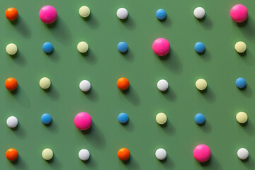 Pills of different colors on a green background. Medical and pharmaceutical concept. Wallpaper
