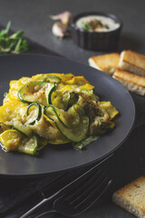 Fried zucchini with melted cheese and garlic in
