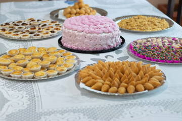 a pink cake and party treats
