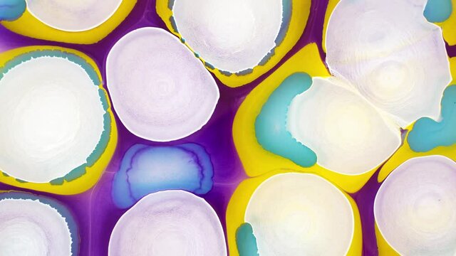 Abstract fluid ink background. Blooming magical white flowers. Ink in liquid. Circles of paint radiating over the surface. Ink-in-liquid. Macro space