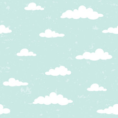 Grunge seamless ornament with white clouds on powder blue background. Speckled pattern.