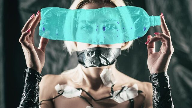 Nft art. Cyber people. Artificial intelligence. Wired clone woman with taped mouth holding looking through colorful glitch noise animation plastic bottle.