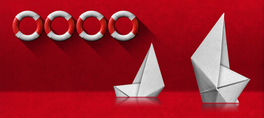 Two white paper boats that are sinking on red background with four white and red lifebuoys.