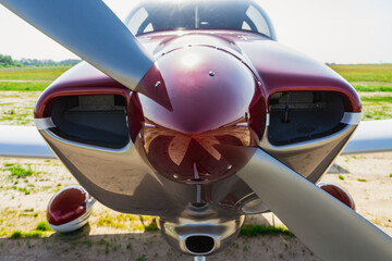 Small private white plane before the flight. Front view. Close-up.