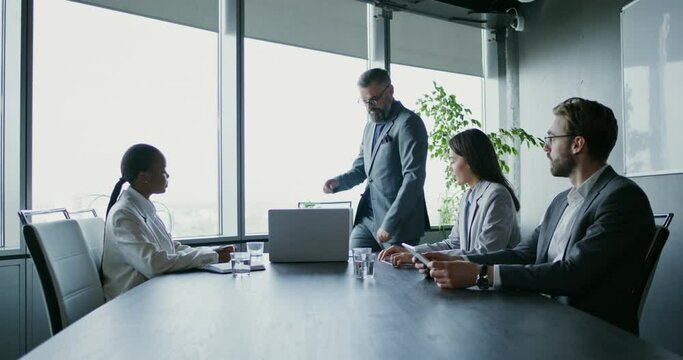 An angry boss scolding his subordinates and waving documents