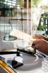 Business and lawyers discussing contract papers with brass scale on desk in office. Law, legal services, advice, justice and law concept picture with film grain effect