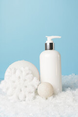 Face cream, nourishing mask jar with decorative snowy background. body lotion or cream. Seasonal care in the winter