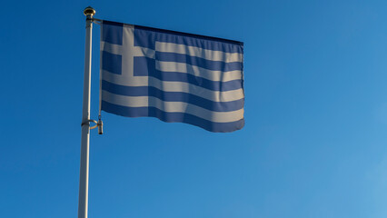 Greek national flag moving in the wind. National symbol of Greece is blue and white greek flag. Diplomacy concept.