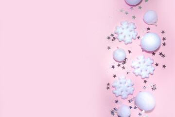 Fluffy Christmas concept. Festive Christmas background with fluffy decoration stuff, xmas ball, gift boxes, with artificial snow and shiny stars on pink color background copy space