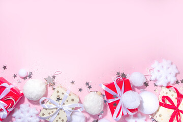 Fluffy Christmas concept. Festive Christmas background with fluffy decoration stuff, xmas ball, gift boxes, with artificial snow and shiny stars on pink color background copy space