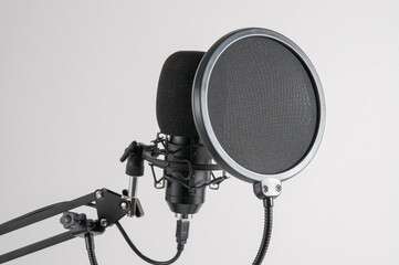 Professional microphone for sound recording, on a light gray background.
