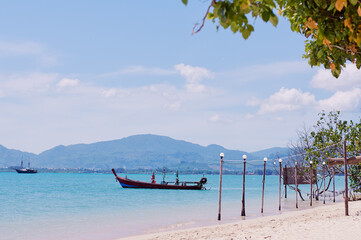 Travel by Thailand. Sea beach with traditional longtail boat.