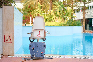 Disabled equipment chair in hotel swimming pool.