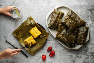 Christmas dish in Venezuela, hallacas, en banana leaf, corn dough stuffed with a stew of pork