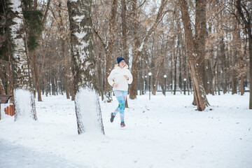 Fototapeta na wymiar Girl on running in park in winter.