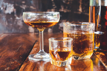  Liquor  glass and liquor bottles on wooden table