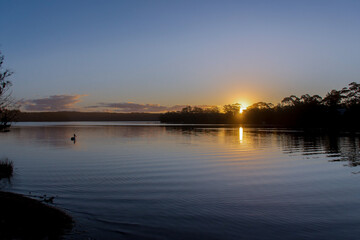 Beautiful sunset on tranquility lake river ocean sea. Water reflections stunning nature background