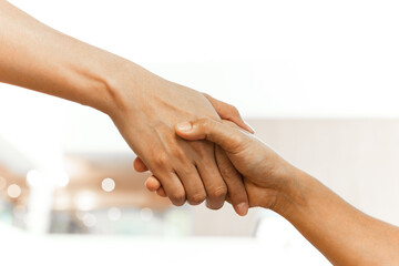 Help Concept hands reaching out to help each other.